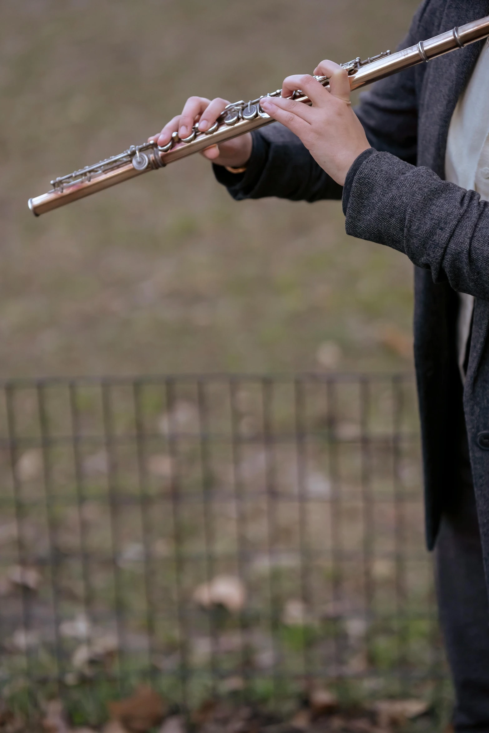 the person is holding an empty flute in their hand