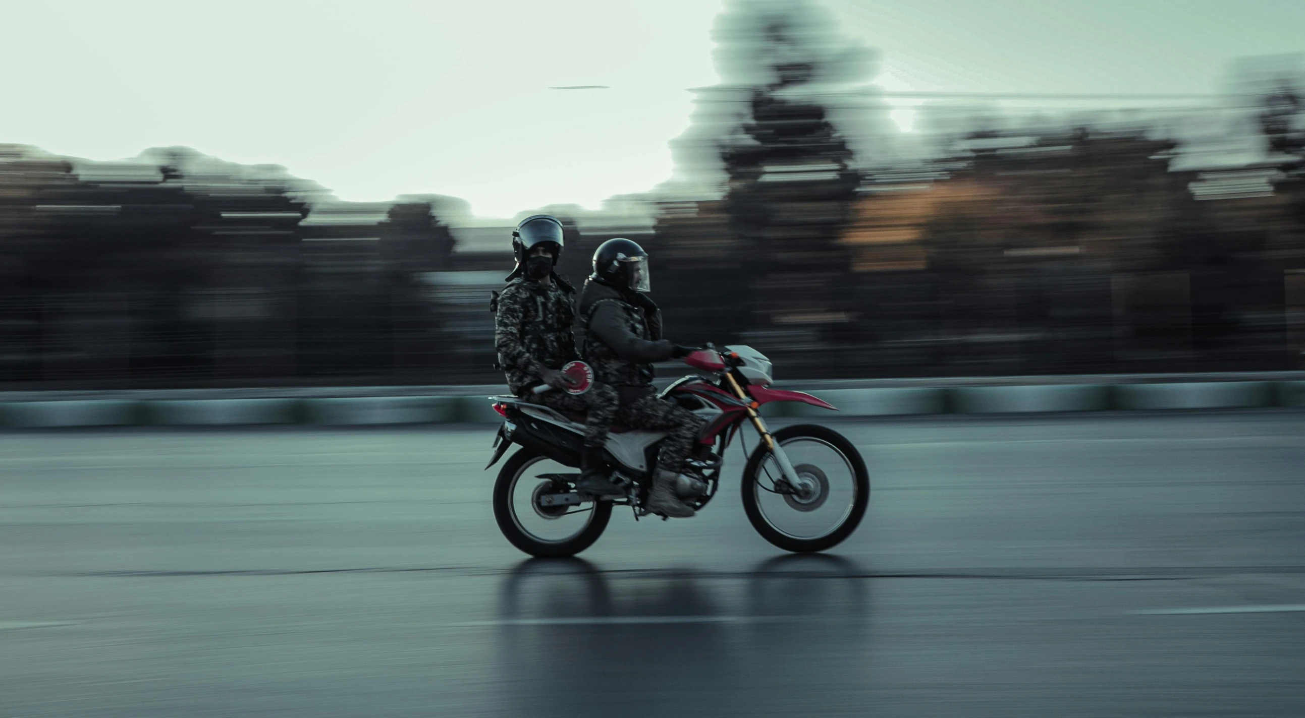 a man on a motorcycle driving on a city street