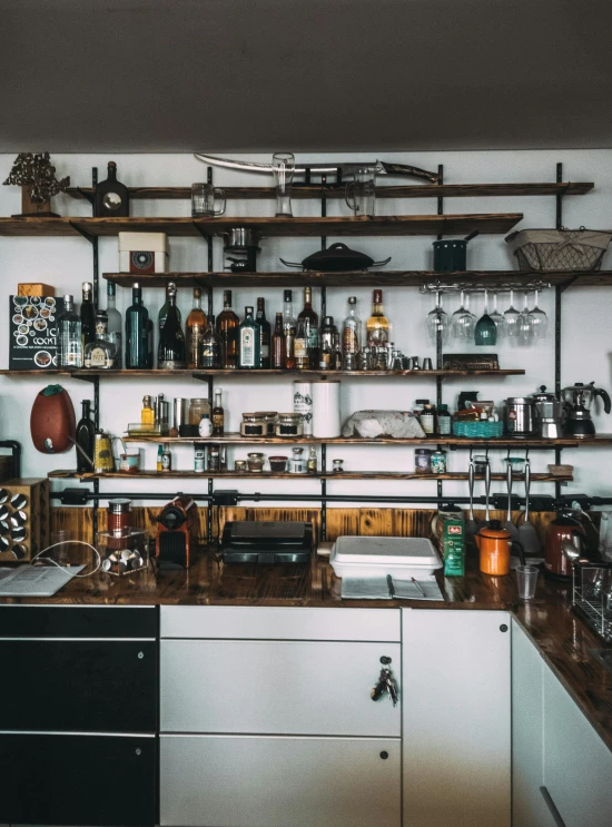 a large open kitchen with many bottles on the shelves