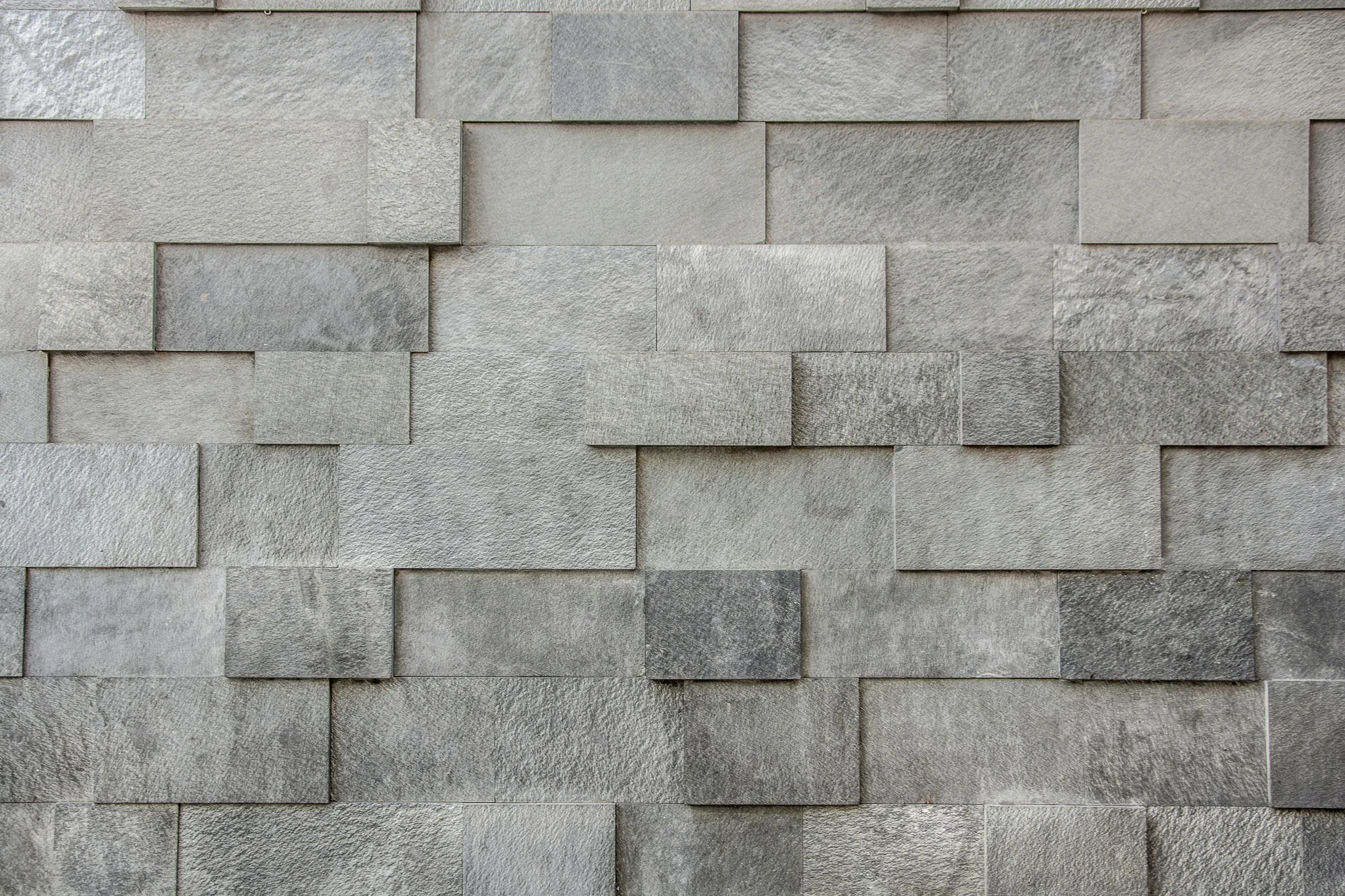 the side view of a grey brick wall