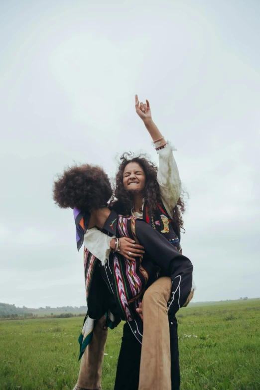 two people holding a white dog on their backs