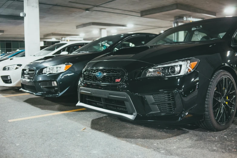 a line of parked cars in a parking garage