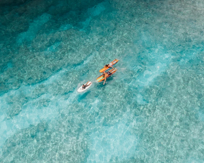 two people are in a kayak in clear blue water