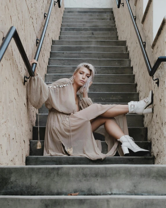 the woman is posing on some stairs near stairs