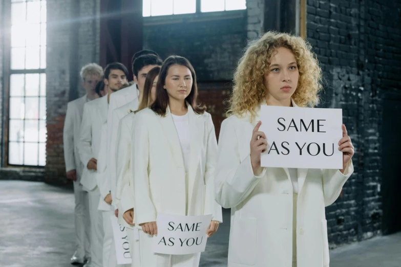 two models hold a sign that reads same as you
