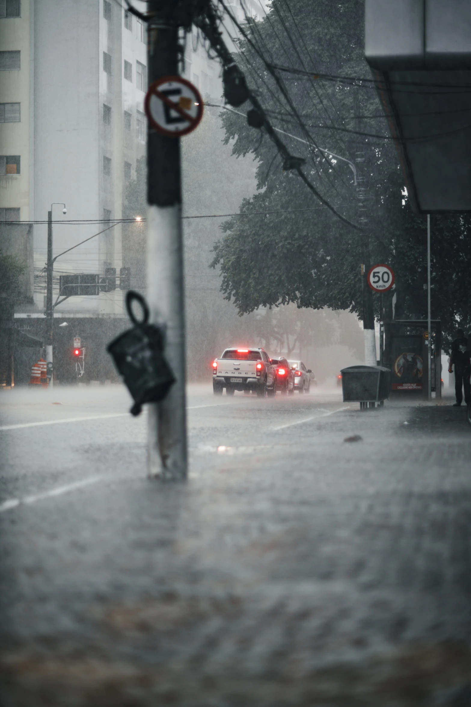 a city street is flooded with heavy rain