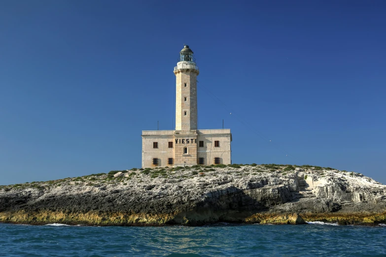 an old tower near the ocean on top of the rocks