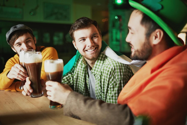 three men are enjoying different alcoholic drinks together