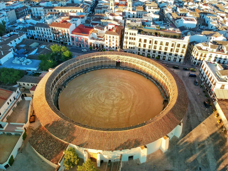 a view of a round building and its surrounding structures