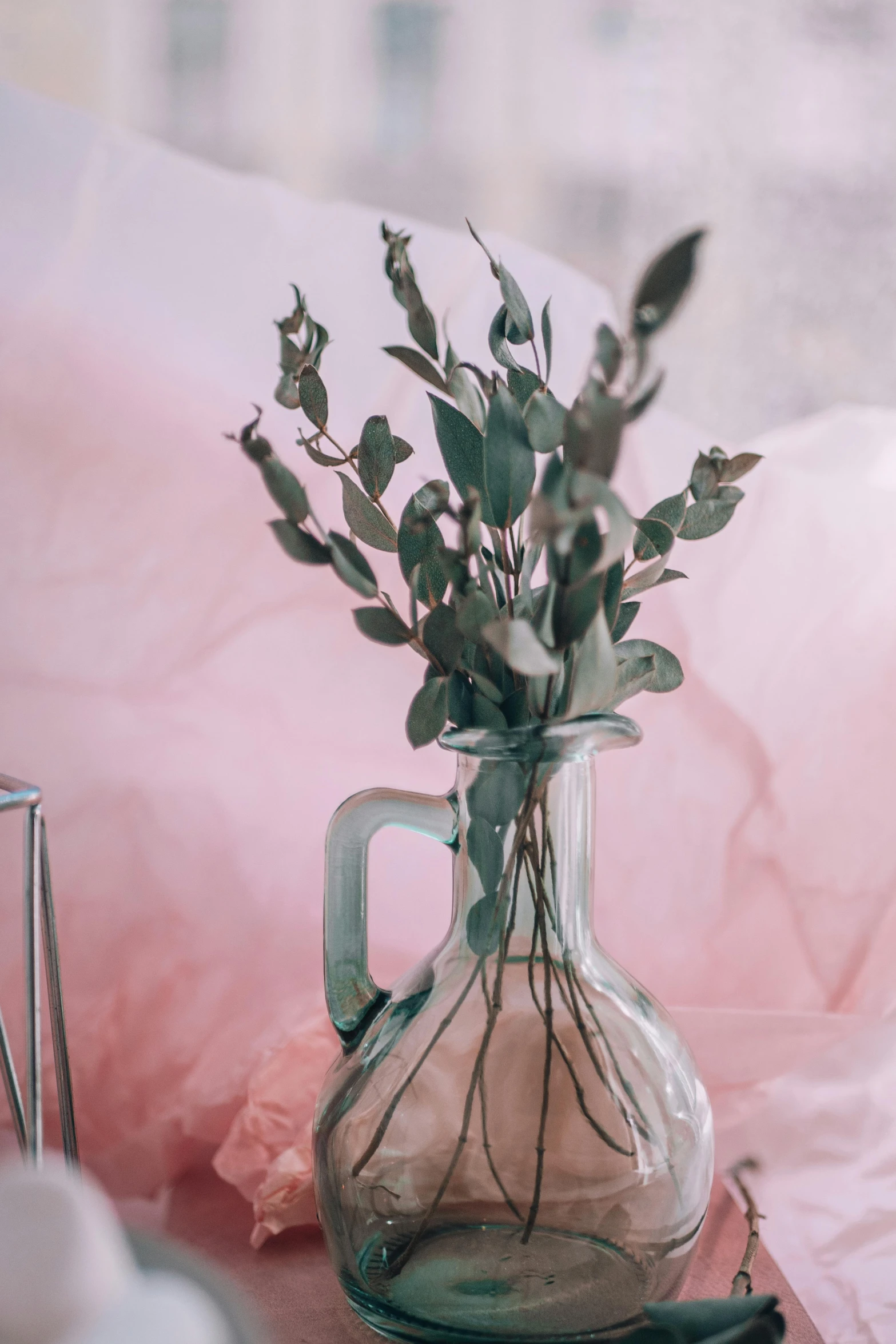 a glass vase sitting on top of a wooden table