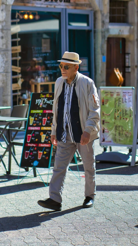 a man walking on a street in front of a building