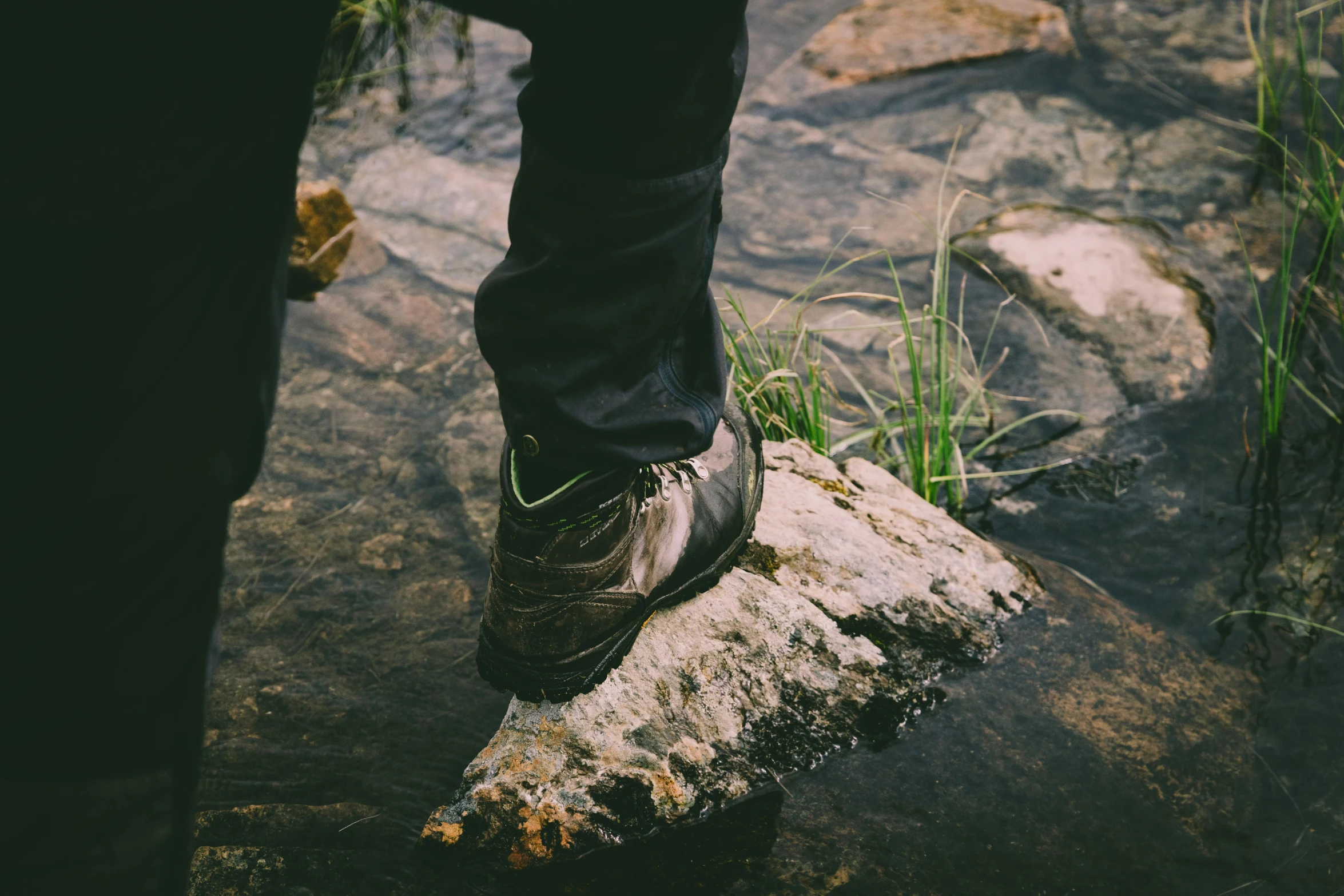 a person with shoes on is stepping over a log