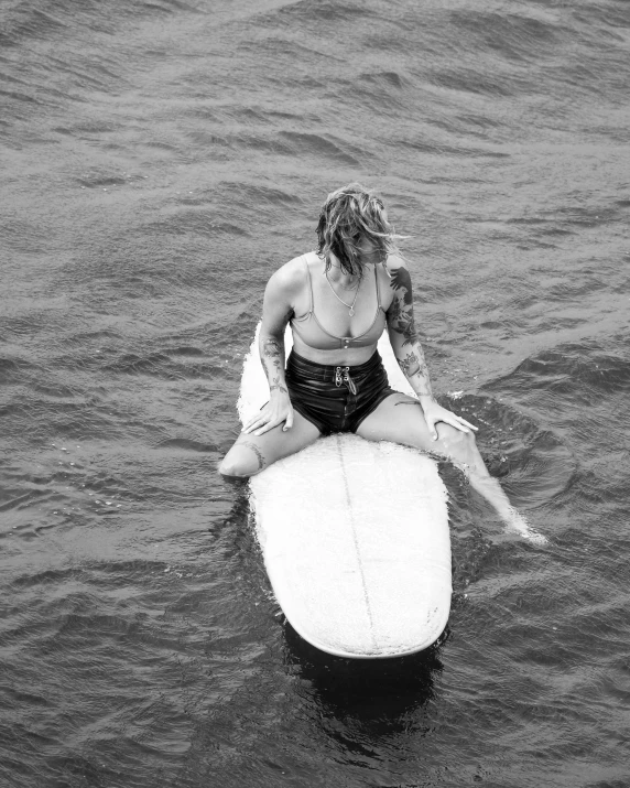 the girl is riding on top of a surfboard