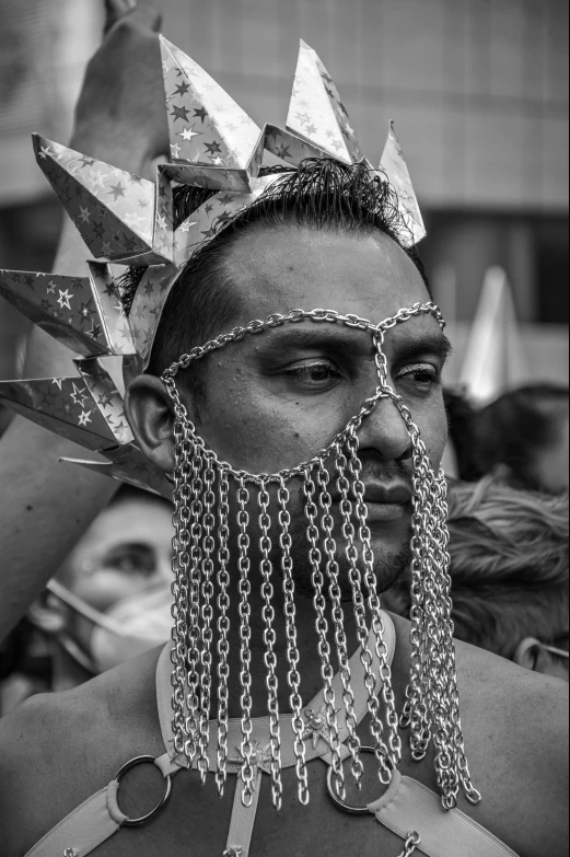 a man wearing an elaborate crown in a parade