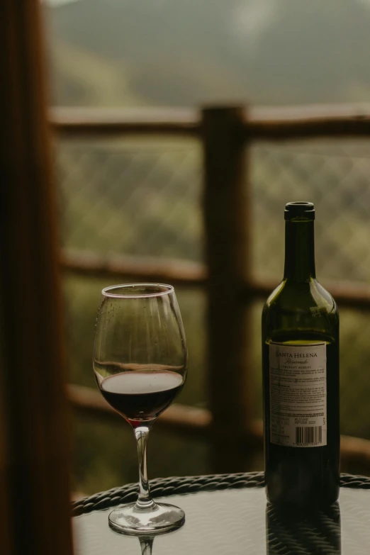 a bottle of wine and glass on a table