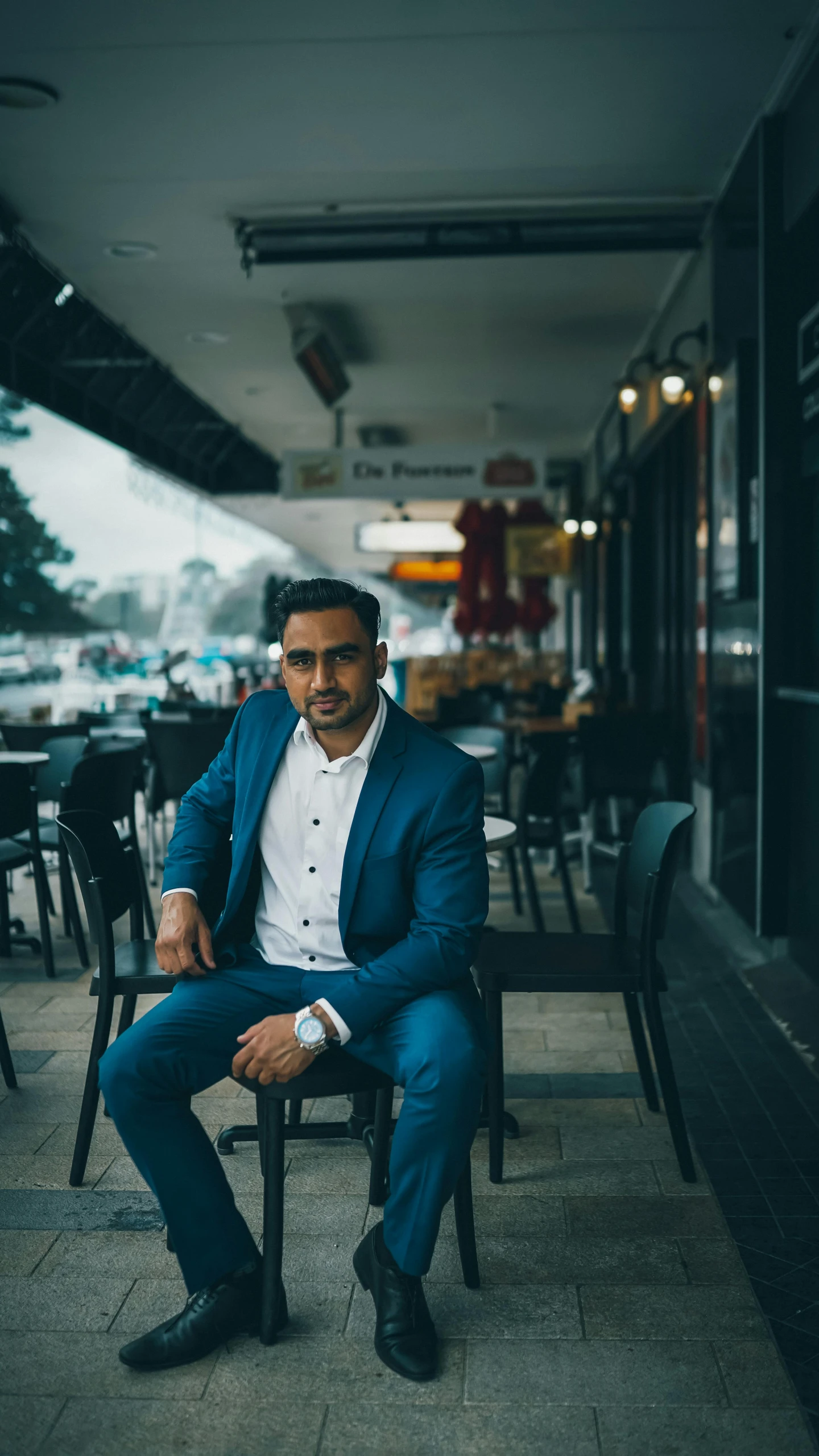 man sitting on a bench in the middle of a restaurant