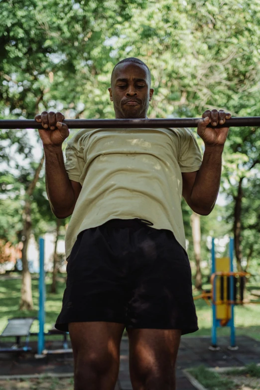 a man with his back on the ground while lifting a bar