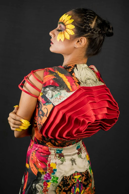 a woman dressed in florals poses with her hands on her hips