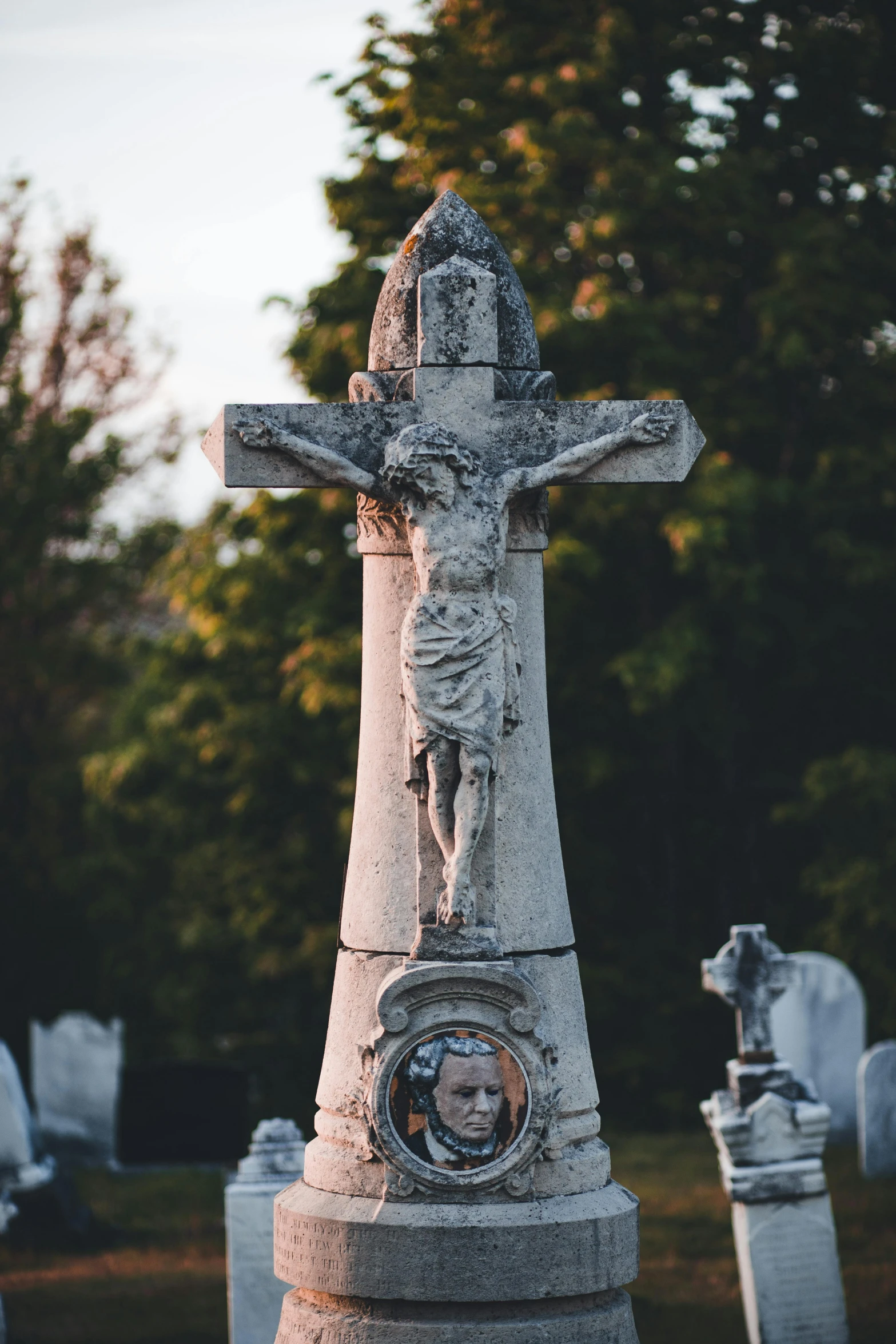 a cemetery with old headstones and the cross