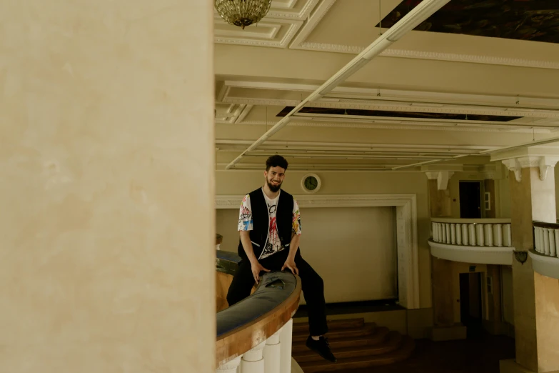 a man sits in the middle of a long hallway