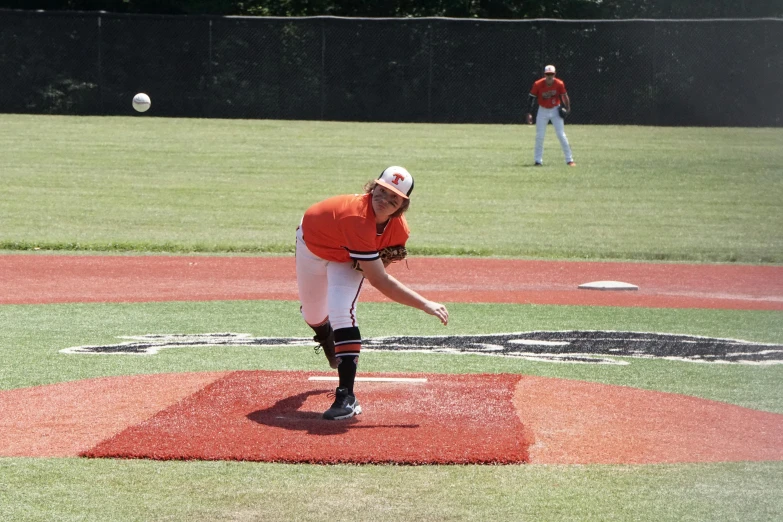 a baseball player throws the ball during a game