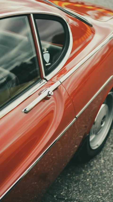 the rear window of an old, red car