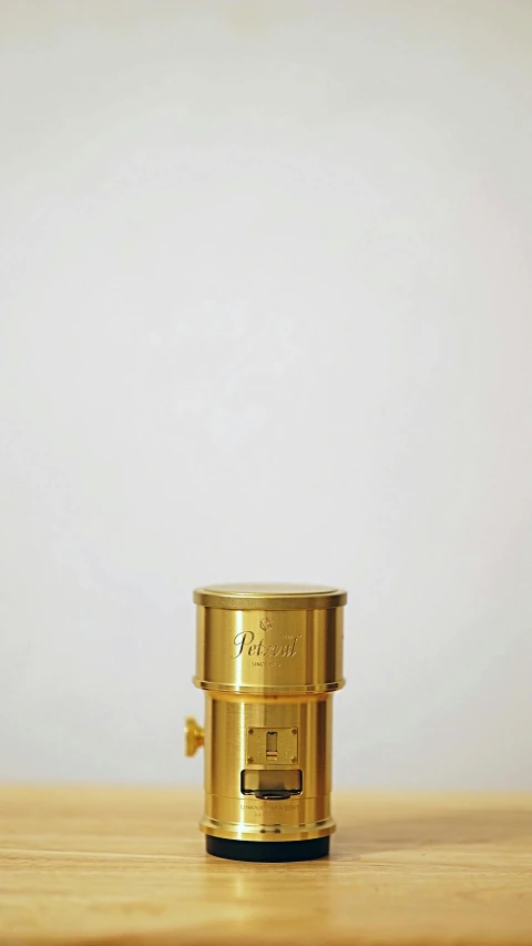 the top portion of the gold container has an opening in the middle