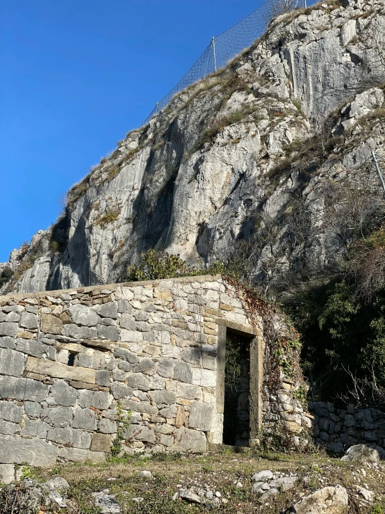 an old stone cave built into the side of a mountain