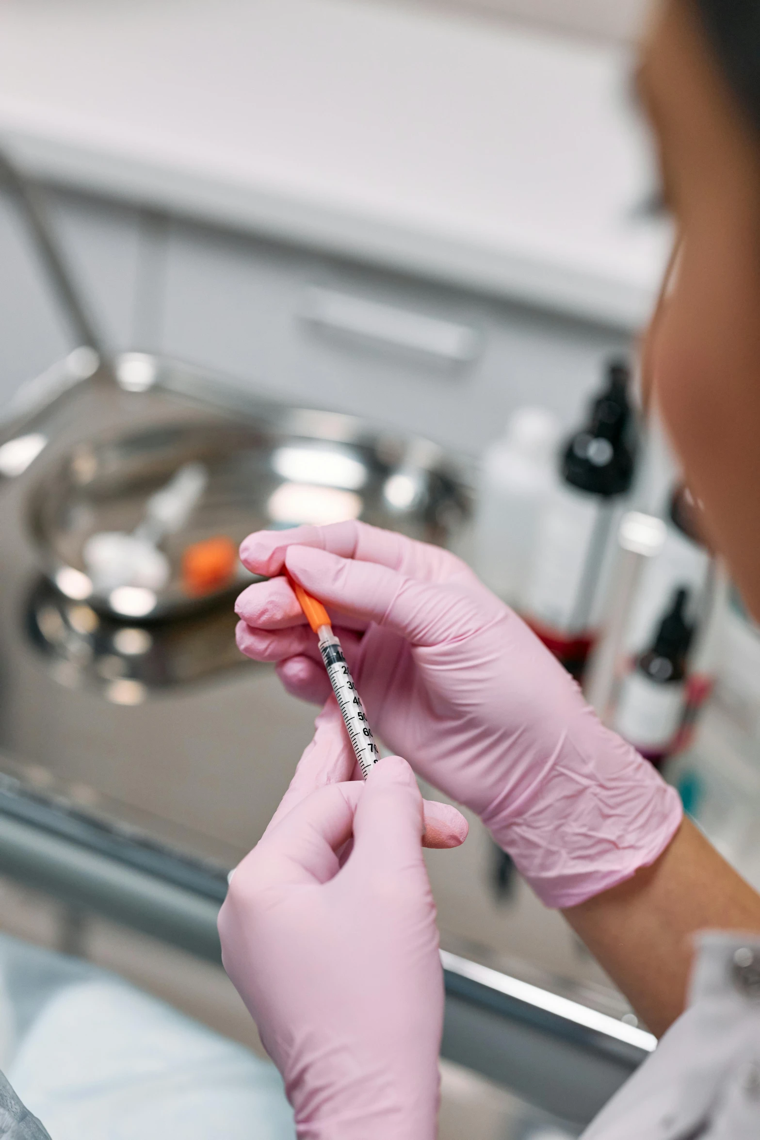 a person with gloves and sterile gloves on writing in a piece of paper