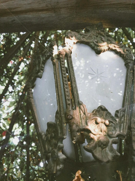 a very ornate mirror is pictured under the tree