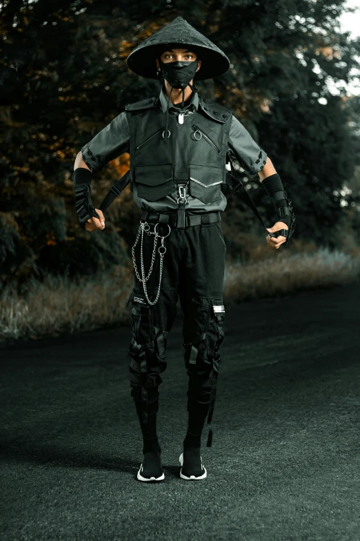 man wearing full body gear and face mask with arms outstretched standing in a open field