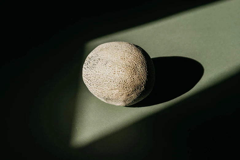 a rock with an extended shadow in the middle