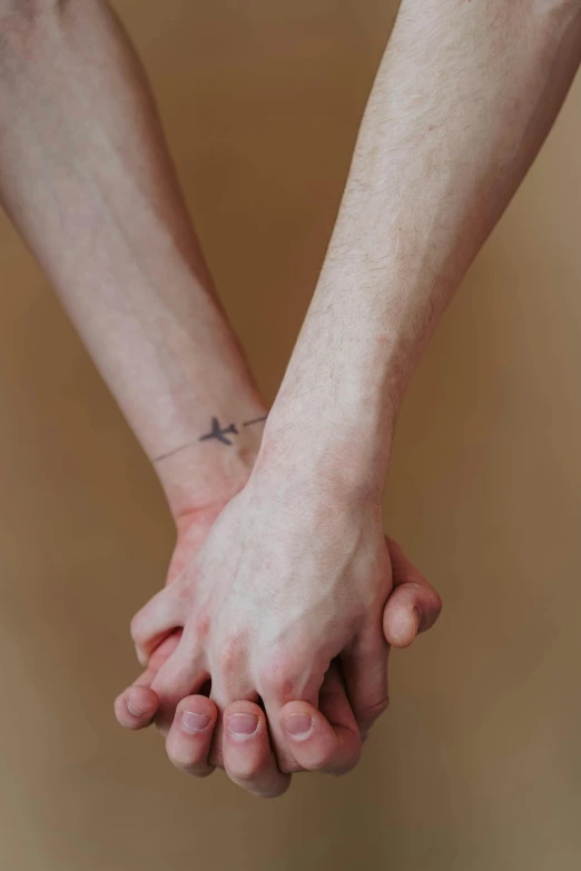 two people hold hands with one holding the other