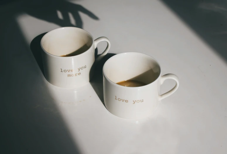 two coffee mugs with the words love you and love you on them