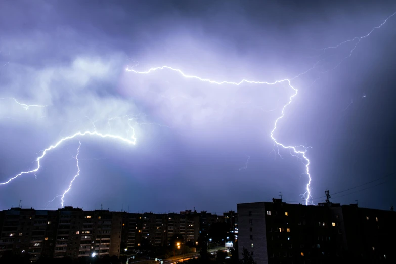 there is an electrical storm in the sky above buildings