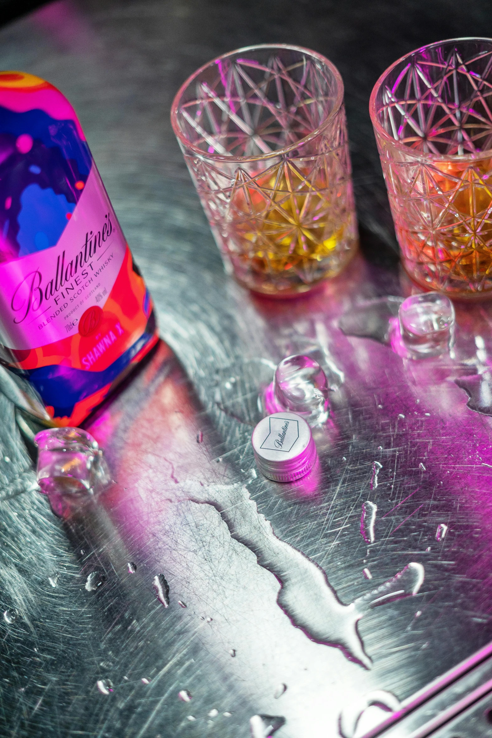 some glasses and a bottle are sitting on the table