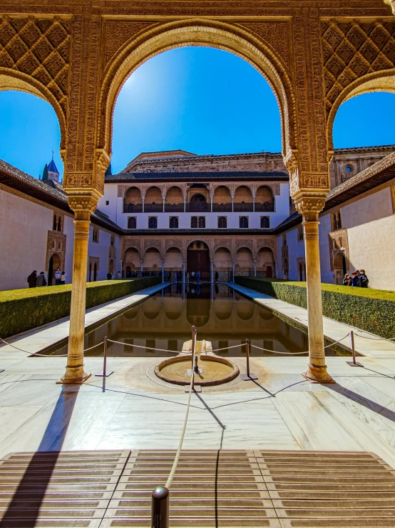 an elegant courtyard with many arches and fountains