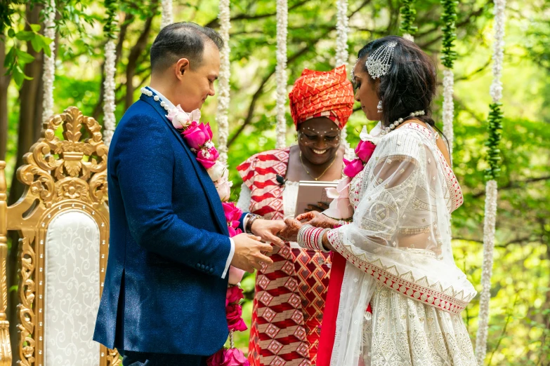 an indian couple getting married under an archway