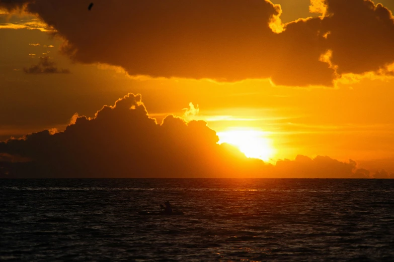 a sunset is seen over the water in an ocean