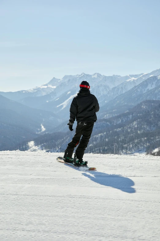 a person with black jacket on standing on skis in the snow