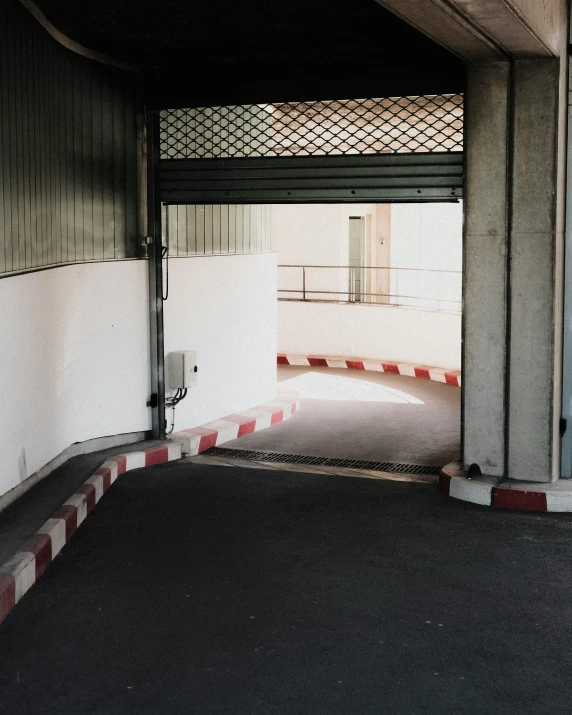 the inside of an empty parking garage with only the door open