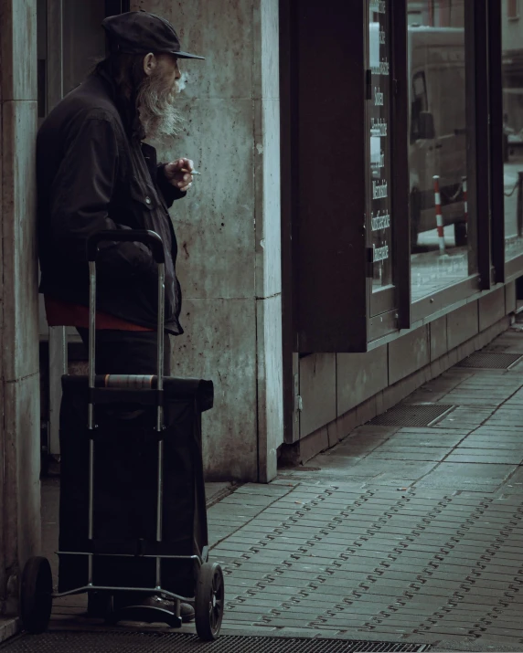 a man smoking a cigarette next to a street