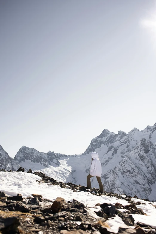 the man stands on top of the snow - covered mountain