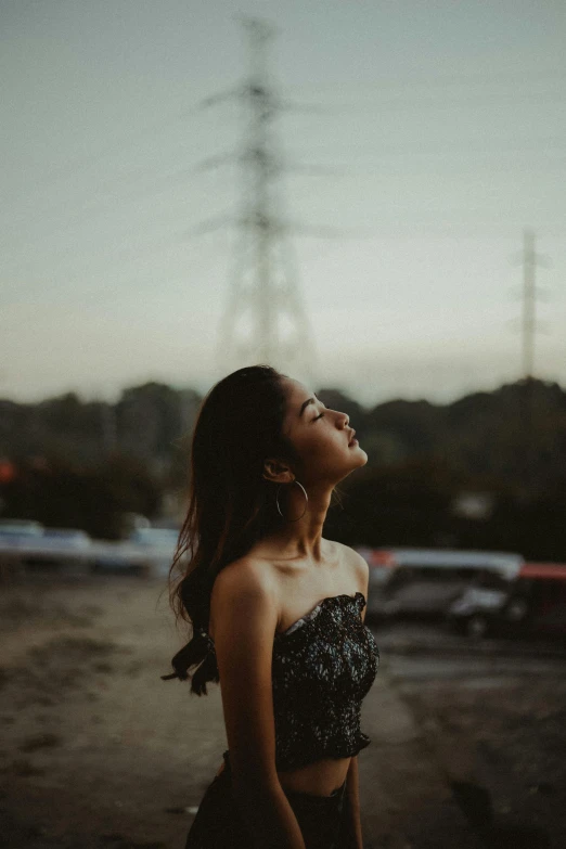 young woman smiling with her eyes closed and looking up to the sky