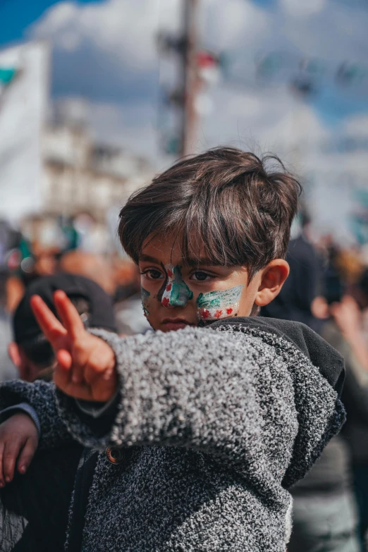 a little boy making the vulcan sign with his hands