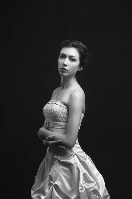 a woman standing in front of a black background