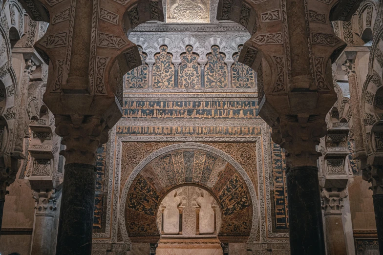 an ornate archway with arches and decorative artwork in the building