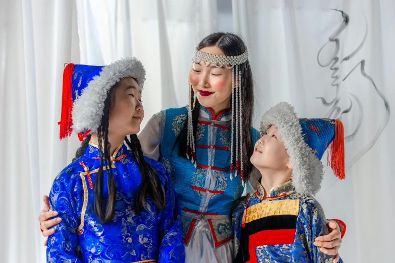 three women in native costumes are standing and talking together