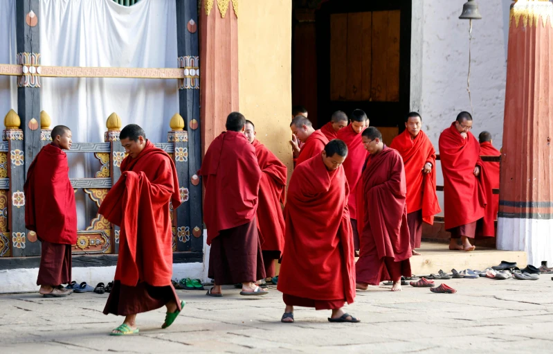 people dressed in red with buddhist robes