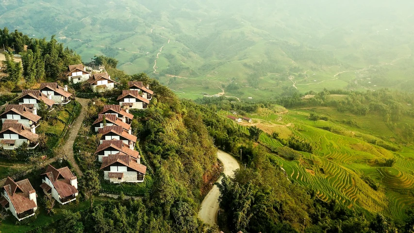 a scenic mountain with trees and houses on the hillside